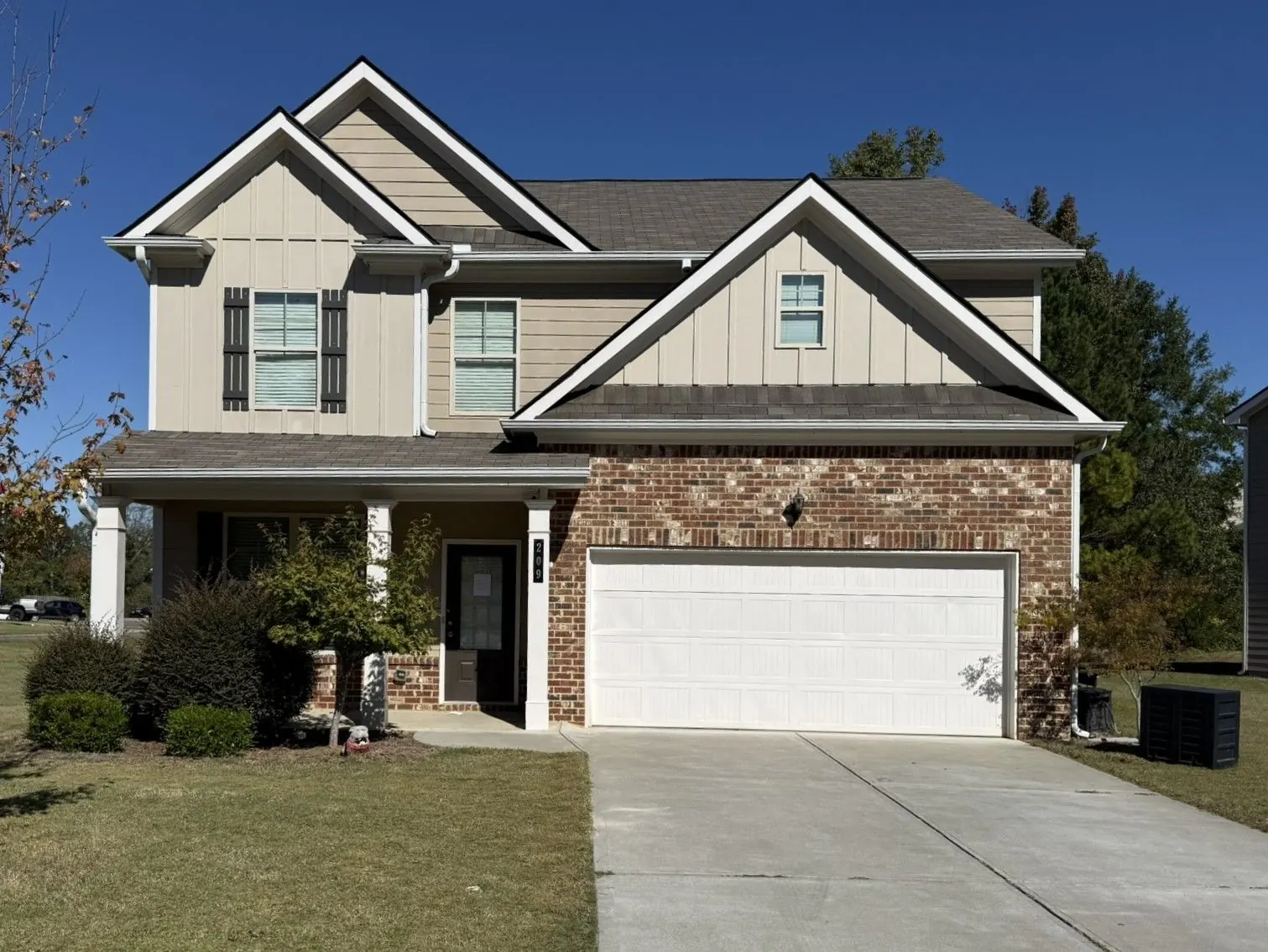 Front of the two-story house with a 2-car garage, 209 McGinnis Cir